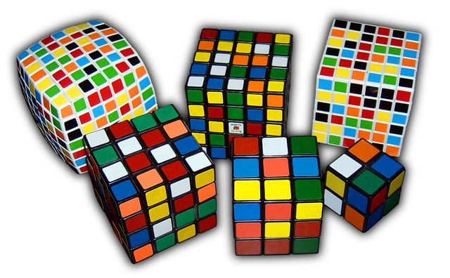 Variations of Rubik's Cubes. Top row: V-Cube 7, Professor's Cube, V-Cube 6. Bottom row: Rubik's Revenge, original Rubik's Cube, Pocket Cube. Clicking on a cube in the picture will redirect to the respective cube's page. (Note:scrambled states)