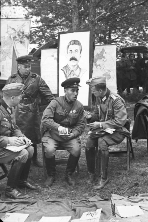 German and Soviet soldiers during the official transfer of Brest to Soviet control in front of picture of Stalin, in the aftermath of the invasion and partition of Poland by Nazi Germany and the Soviet Union in 1939.