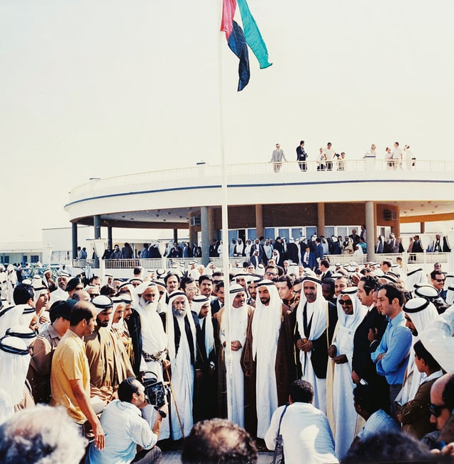 Historic photo depicting the first hoisting of the United Arab Emirates flag by the rulers of the emirates at The Union House, Dubai on 2 December 1971