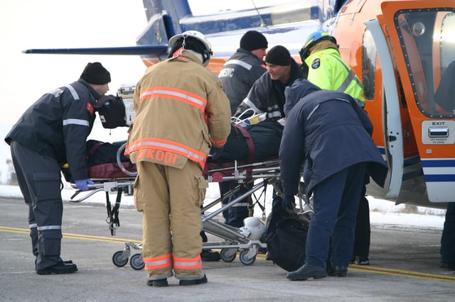 Paramedics load an injured woman into an air ambulance after a head-on collision in the Kawartha Lakes region of Ontario, Canada.