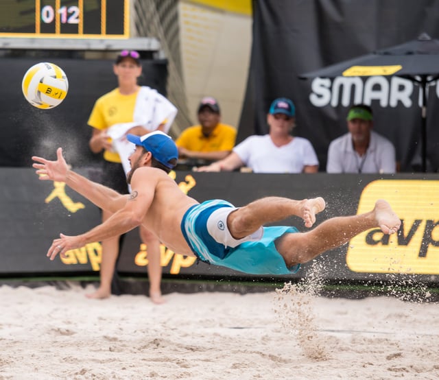 Unlike indoor volleyball, beach volleyball is played on soft sand which makes it safer for players to dive. Picture shows Nick Lucena of the United States diving to "dig" the ball.