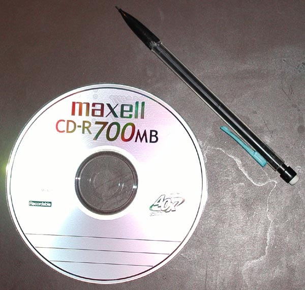 700 MiB CD-R next to a mechanical pencil for scale