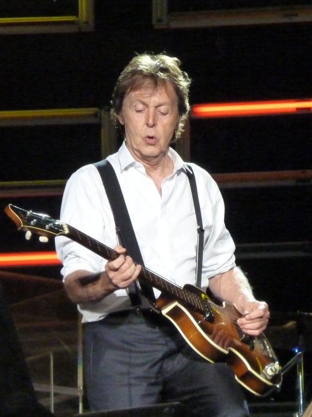 Paul McCartney mutes strings with picking hand.