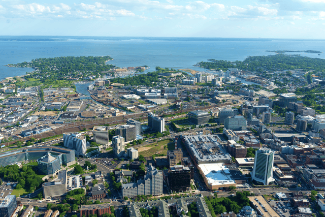 Aerial view of the Downtown and South End neighborhoods of Stamford with Long Island in the distance.