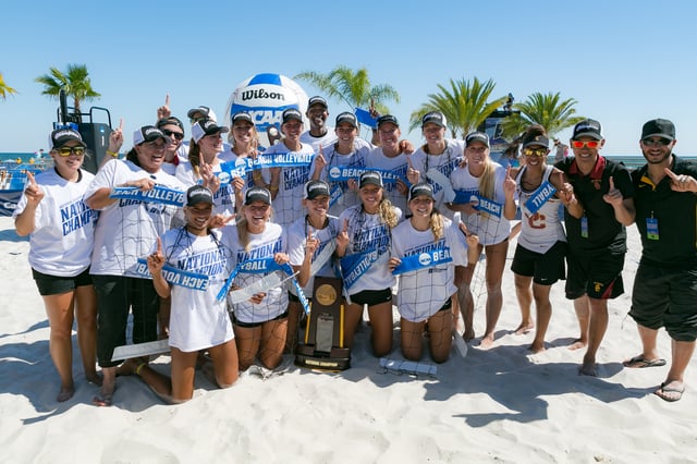 The USC Trojans women's beach volleyball team poses with the National Championship trophy after winning the inaugural 2016 NCAA Beach Volleyball Championship.