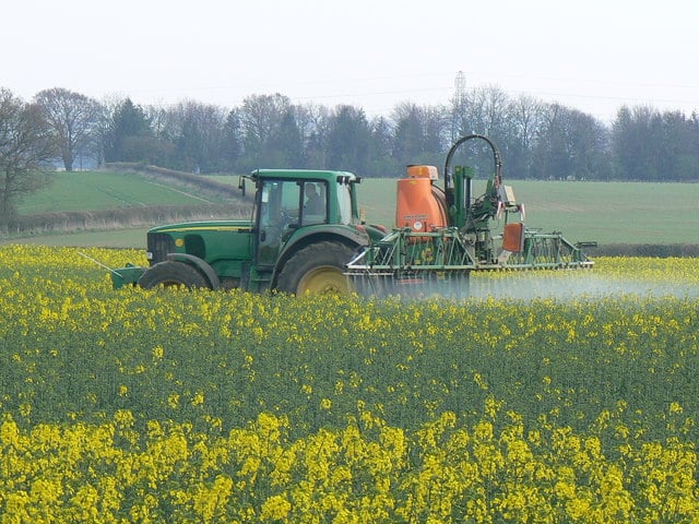 Spraying a crop with a pesticide