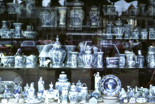 Shop window display of Delftware in the market place, Delft. East Asian-inspired Delftware, a lasting cultural and economic legacy of the VOC era.