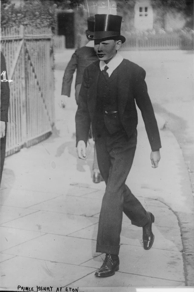 Prince Henry, Duke of Gloucester in 1914 dress of a junior Eton pupil, wearing a top hat, neck-tie and "bum-freezer", none of which are now worn