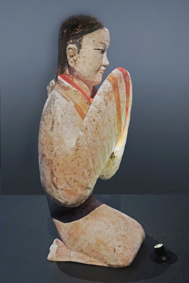 A Western Han (202 BC - 8 AD) ceramic statuette of a seated woman and court attendant holding up her robes, from a tomb of Xianyang, Shaanxi province