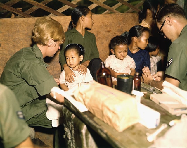 A nurse treats a Vietnamese child, 1967