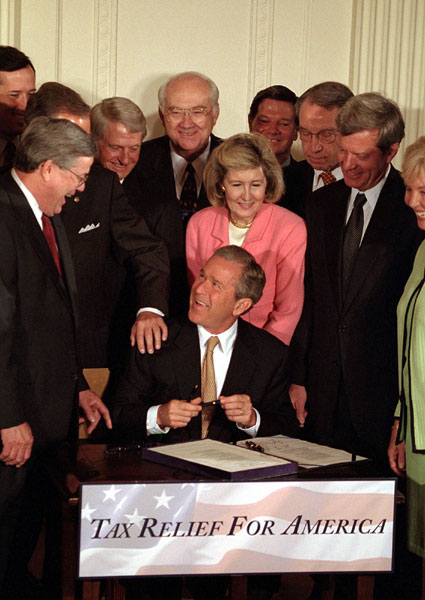 President Bush signing a $1.35 trillion tax cut into law, June 7, 2001