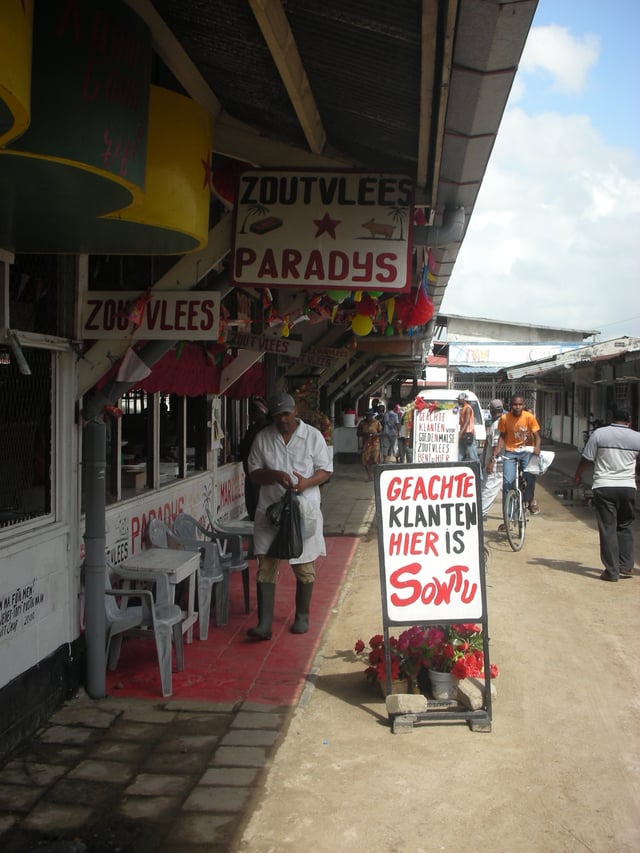 Butcher market in Paramaribo with signs written in Dutch.