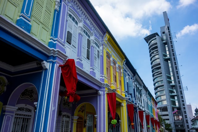 A row of renovated shophouses in George Town, repainted in vibrant colours.