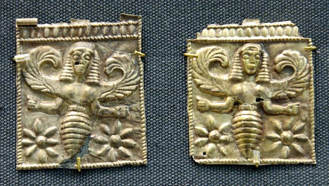 Gold plaques embossed with winged bee goddesses.
