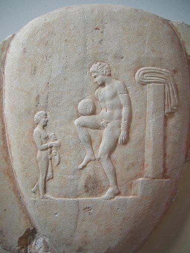 An episkyros player on an ancient stone carving at the National Archaeological Museum, Athens.