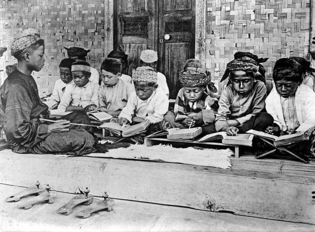Children studying Qur'an in Java, Indonesia, during colonial period