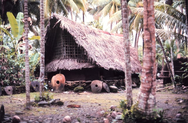 Traditional style structure with stone money indicating great wealth. The first stones were mined on Palau and carried by outrigger canoe some 450 kilometers (280 mi).