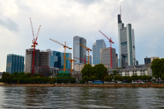 Frankfurt's skyline from across the Main, showing construction cranes