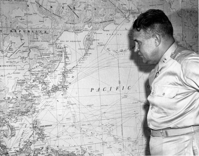 Leslie Groves, Manhattan Project director, with a map of Japan