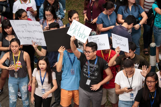 Students of the Ateneo de Manila University along Katipunan Avenue protesting against the burial of Marcos insisting that the former President is not a hero, but a dictator.