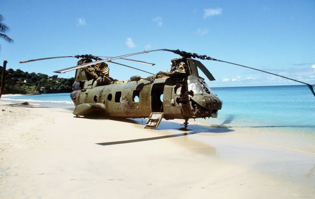 A Marine Corps Sea Knight helicopter sits on the beach after being shot down by anti-aircraft fire on 25 October 1983