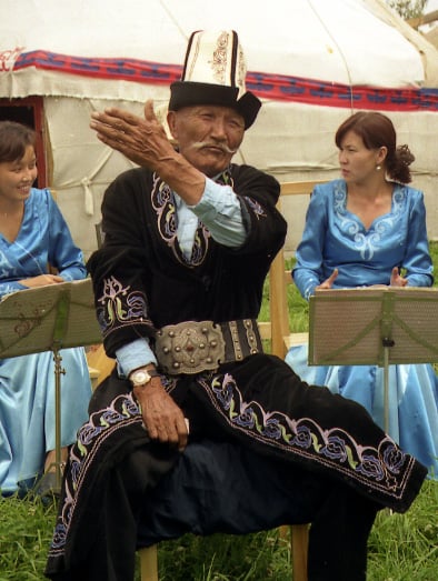 A traditional Kyrgyz manaschi performing part of the Epic of Manas at a yurt camp in Karakol