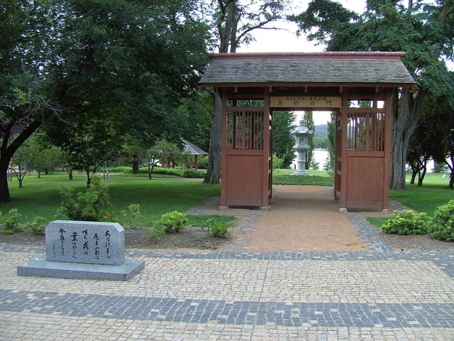 Canberra–Nara park with Kasuga stone lanterns framed by the gate