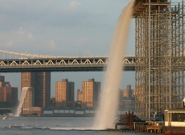 Waterfall under the Brooklyn Bridge. The bridge in the background is the Manhattan Bridge.