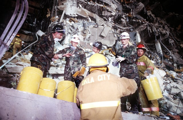 U.S. Air Force personnel and firefighters removing rubble in the rescue attempt