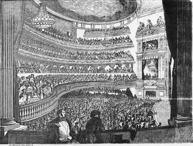 View of the auditorium from the a stage box showing the two chandeliers