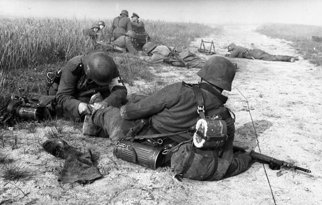 A German military medic providing first aid to a wounded soldier