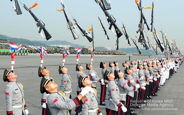 South Korean soldiers toss bayonet mounted M16 rifles into the air at the celebration ceremony for the 65th Anniversary of the South Korean armed forces