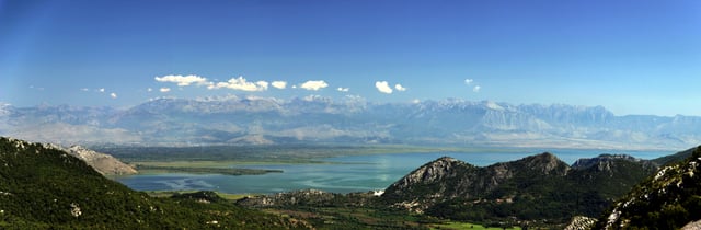 Panoramic view above the Lake of Shkodër towards the Albanian Alps. Being the largest lake in Southern Europe, it is designated as a Nature Reserve as well as a Ramsar Site.