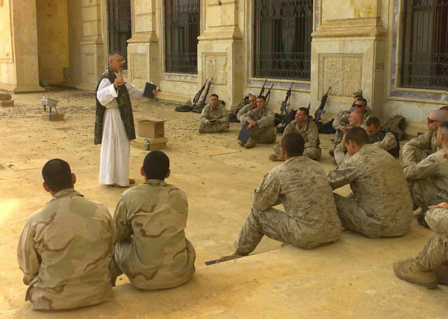 A Catholic chaplain ministers to American Marines and Sailors in Tikrit, Iraq