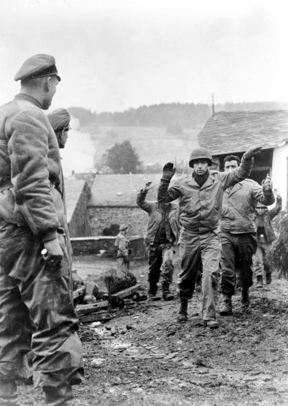 American soldiers of the 3rd Battalion 119th Infantry Regiment are taken prisoner by members of Kampfgruppe Peiper in Stoumont, Belgium on 19 December 1944.