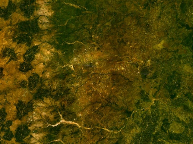 Satellite image of Enugu and other communities neighbouring it. The Enugu escarpment can be seen on the left where it has a lighter colour; the Nyaba River can be seen on the bottom.