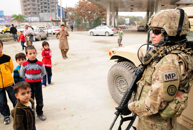 An American soldier standing with children at Freedom Circle (2011)