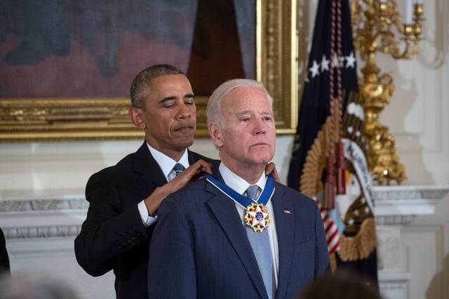 President Barack Obama presents Vice President Joe Biden with the Presidential Medal of Freedom with Distinction during a tribute to the Vice President in the State Dining Room of the White House, January 12, 2017.