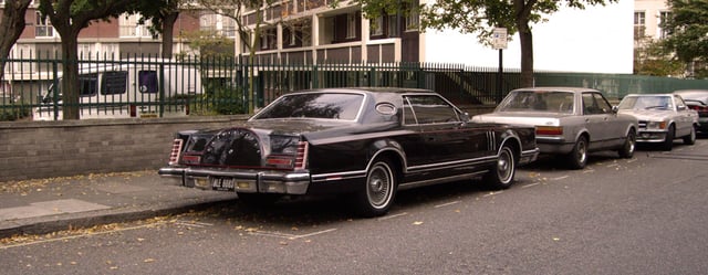 Rear 3/4 view of a Continental Mark V. Pictured is an example of the Mark V without a vinyl roof (rare).