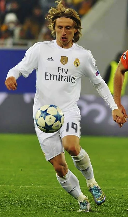 Real Madrid's jersey (worn by Luka Modrić in 2015) is manufactured by Adidas, with Emirates the shirt sponsor