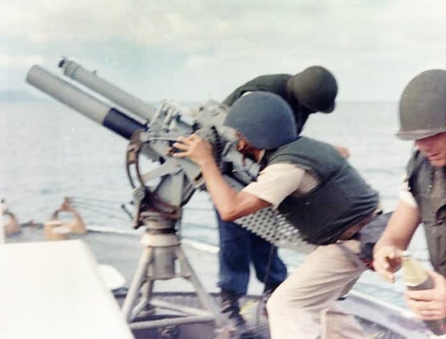 Gun crew on board USCGC Point Comfort (WPB-82317) firing 81mm mortar during the bombardment of suspected Viet Cong staging area one mile behind An Thoi in August 1965