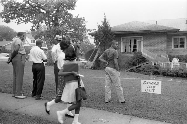 Locals viewing the bomb-damaged home of Arthur Shores, NAACP attorney, Birmingham, Alabama, on September 5, 1963. The bomb exploded on September 4, the previous day, injuring Shores' wife.