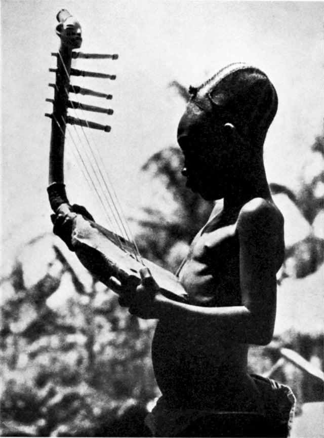 A Mangbetu man playing a bow harp.