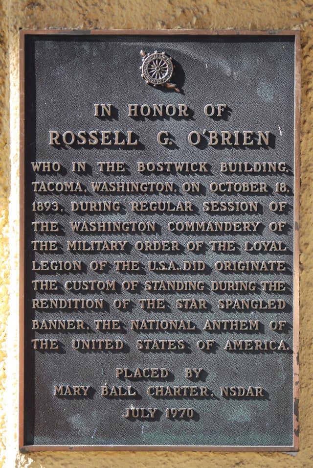 Plaque detailing how the custom of standing during the U.S. national anthem came about in Tacoma, Washington, on October 18, 1893, in the Bostwick building