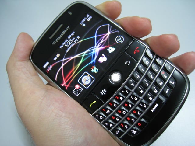 BlackBerry held in hand featuring all the different selective hardware and software on the screen.