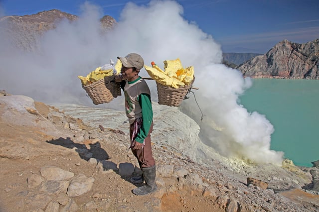 A man carrying sulfur blocks from Kawah Ijen, a volcano in East Java, Indonesia, 2009