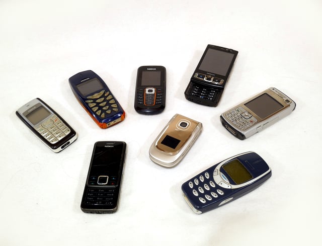 A collection of Nokia mobile phones from the 2000s