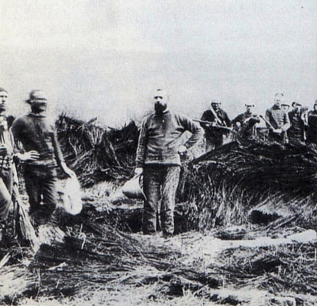 Destroyed umuzi near where Prince Imperial was killed; man in center is possibly Padre George Smith, the Vicar of Estcourt & Honorary Chaplain of the Weenen Yeomanry