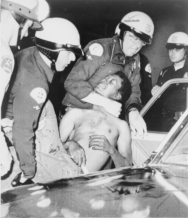 Police arrest a man during the Watts Riots, August 1965
