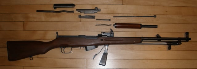 A field-stripped SKS carbine (disassembled into major components for cleaning).